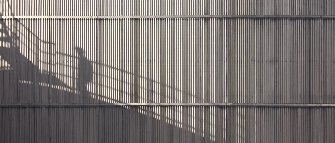 The shadow of a Stena Oil worker on the side of a oil tank